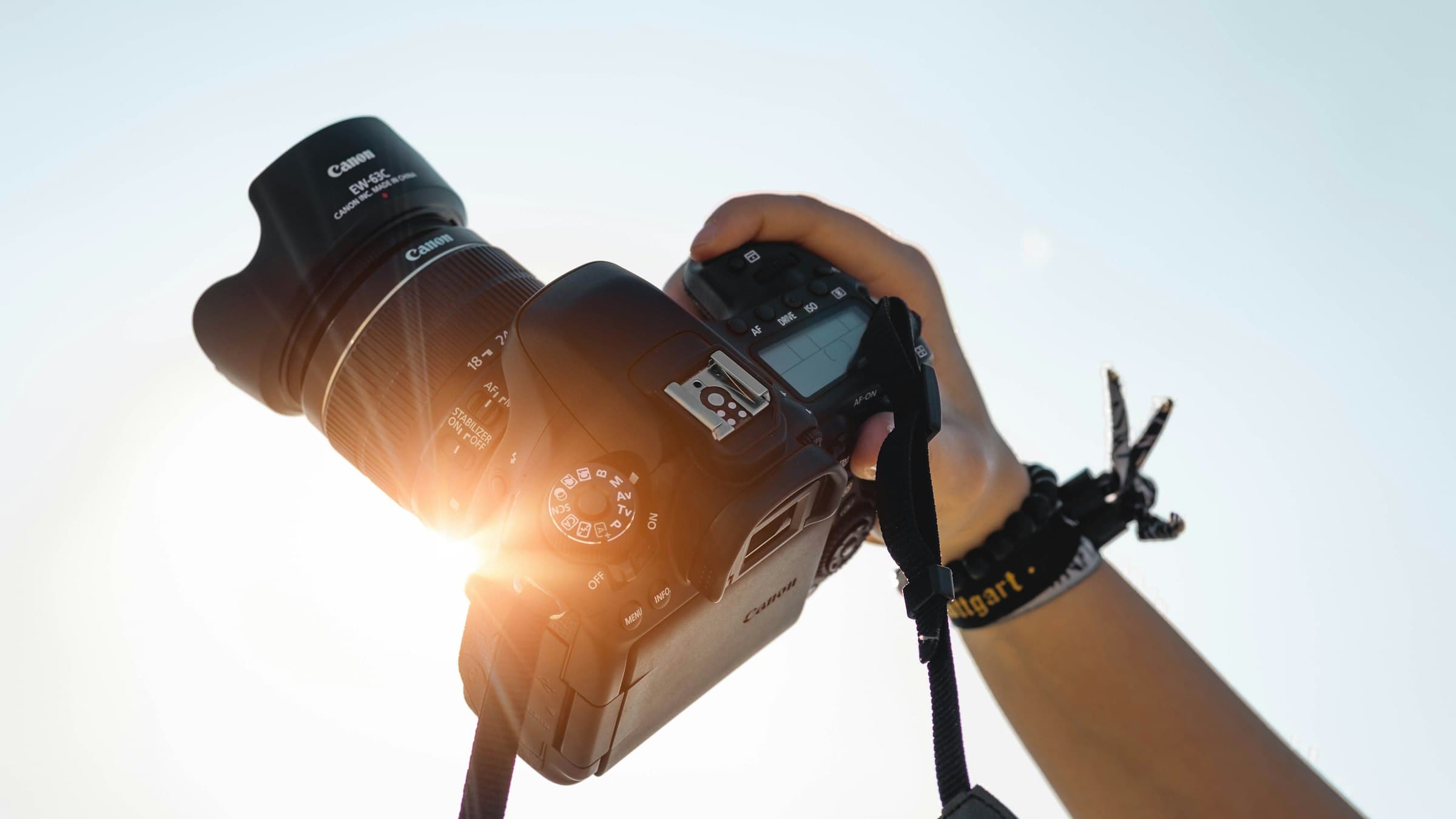 A creator raising a camera toward the sky